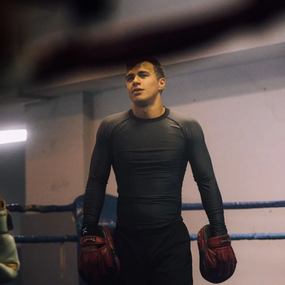 Boxer training in the ring with focus mitts